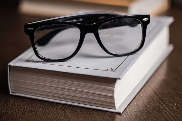 Picture of black glasses on a white book