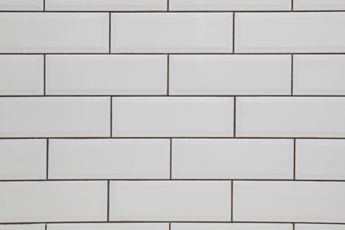 White subway tile wall and dark grout for a kitchen or bathroom backsplash
