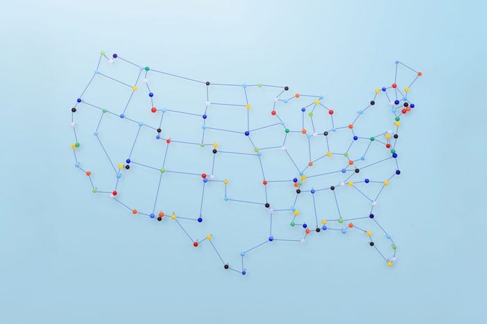 united states map made with pins and string on blue background