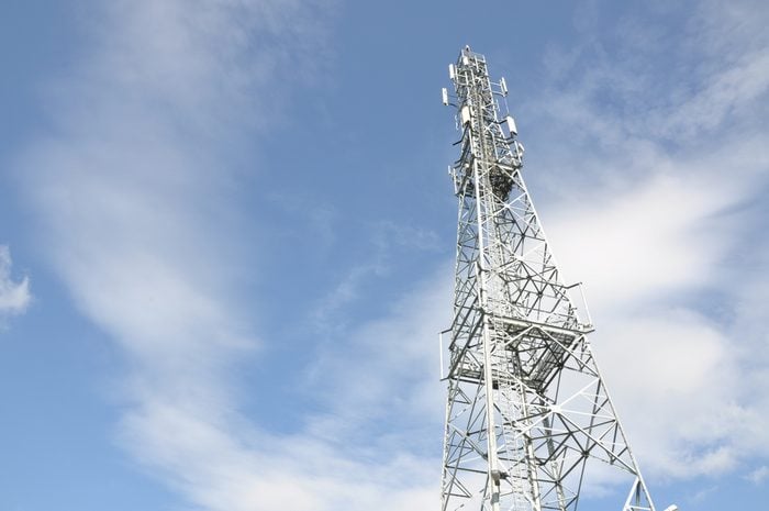 Telecommunication tower with blue and cloudy sky