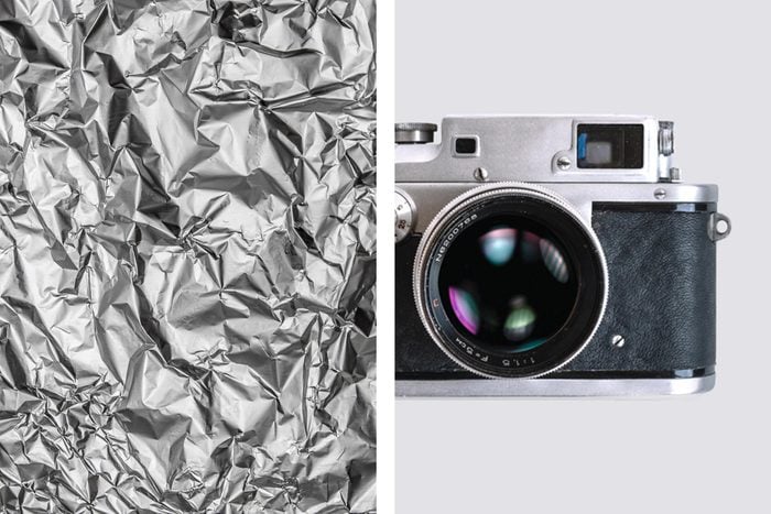 Aluminum foil texture next to vintage film camera