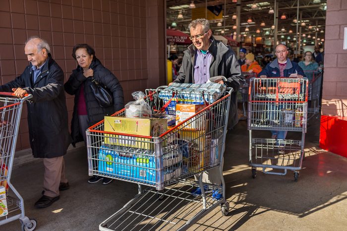 Fairfax, USA - December 3, 2016: People with shopping carts filled with groceries walking out of Costco store in Virginia