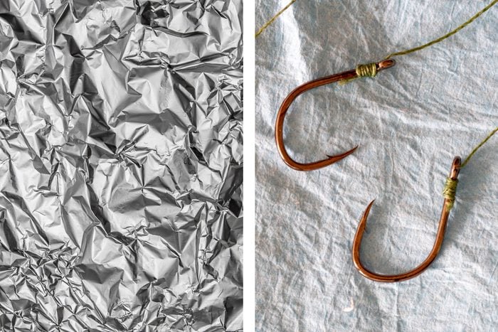 Aluminum foil texture next to traditional fishing hooks