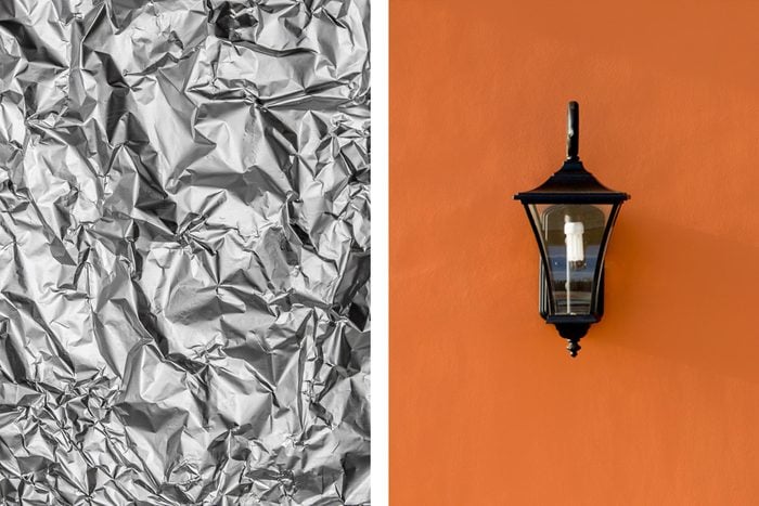 Aluminum foil texture next to outdoor wall sconce light