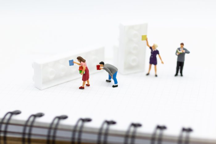 Miniature people: Student group reading books at the library. Image use for education concept.
