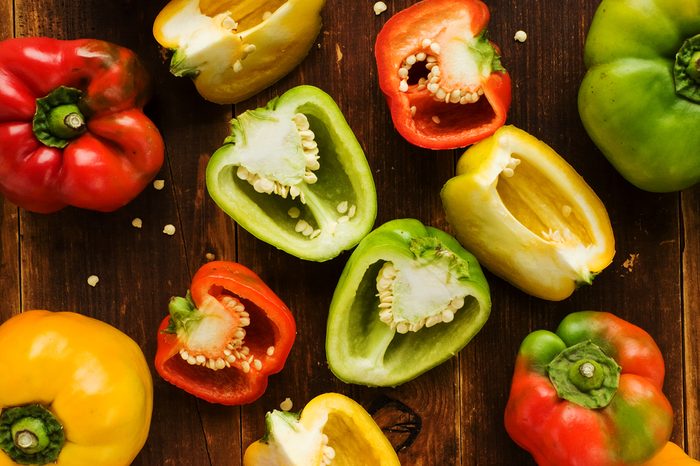 Group of colorful peppers on the wooden background. Viewed from above.