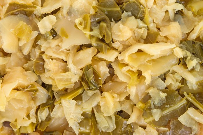 A very close view of shredded and seasoned cooked cabbage.