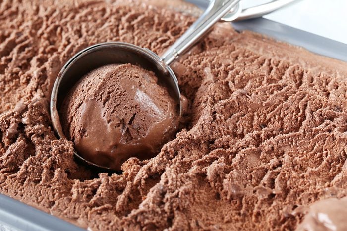 Chocolate ice cream scooped out from container