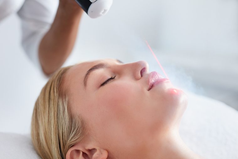 Close up of face of young woman receiving local cryotherapy. Beauty treatment using vaporized nitrogen.