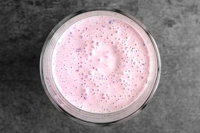 Glass of tasty smoothie on grey table