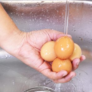 Men Hands Washing Eggs At The Sink