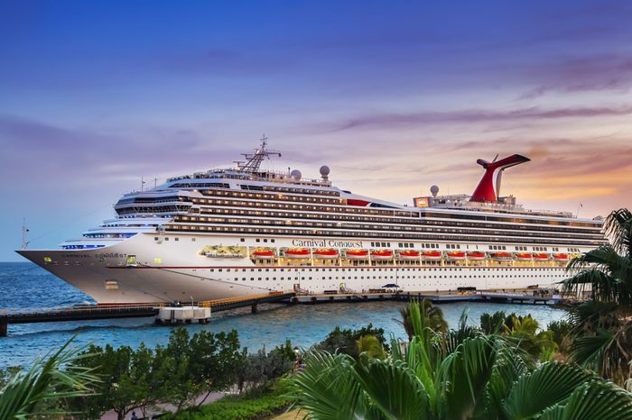 WILLEMSTAD, CURACAO - APRIL 04, 2018: Cruise ship Carnival Conquest docked at port Willemstad on sunset.