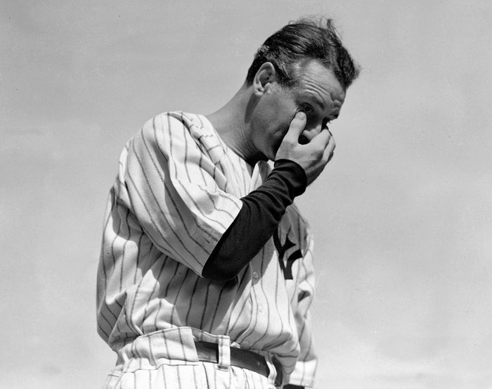 Lou Gehrig wipes away a tear while speaking during a tribute at Yankee Stadium in New York.