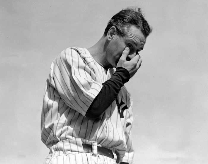 Lou Gehrig wipes away a tear while speaking during a tribute at Yankee Stadium in New York.