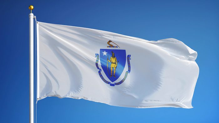 Massachusetts (U.S. state) flag waving against clear blue sky, close up, isolated with clipping path mask alpha channel transparency, perfect for film, news, composition