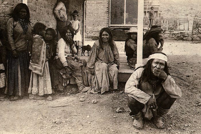 Art (History) - various GERONIMO (Goyathlay, "One who Yawns"), 1829-1909 Apache Indian Chief (crouching, foreground) and Chiricahua Indians at Fort Bowie, Arizona, USA,1880s, after their surrender to U.S. army, showing worn-out moccasins (because of being kept on the move by troops, they had no time to kill stock and make new shoes)