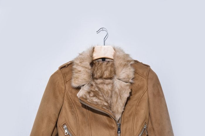 Warm winter jacket isolated on a white background. Women clothes coat Of artificial leather and fur