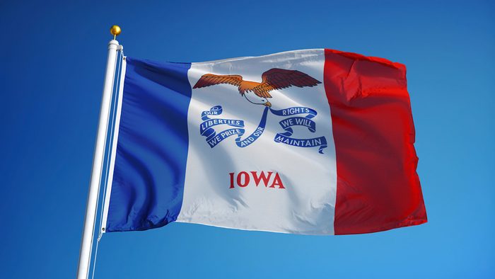 Iowa (U.S. state) flag waving against clear blue sky, close up, isolated with clipping path mask alpha channel transparency, perfect for film, news, composition