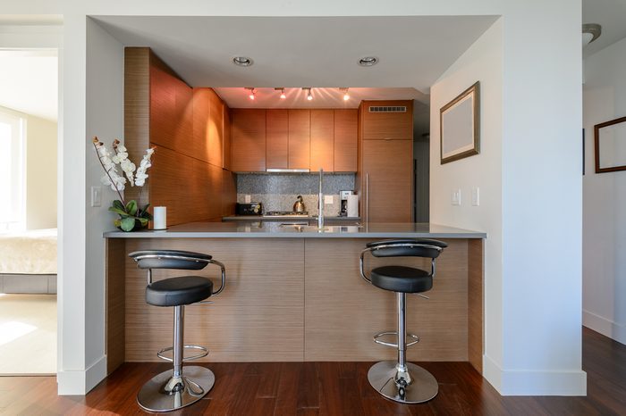 Bright modern kitchen with leather bar stools. Interior design.