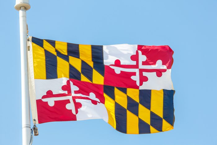 The flag of the state of Maryland against blue sky