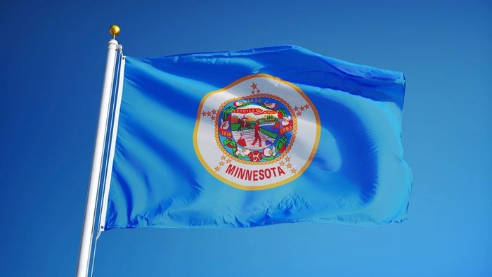 Minnesota (U.S. state) flag waving against clear blue sky, close up, isolated with clipping path mask alpha channel transparency, perfect for film, news, composition
