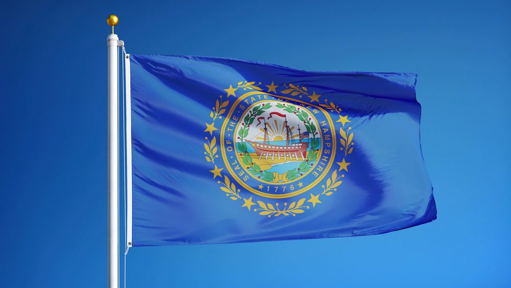 New Hampshire (U.S. state) flag waving against clear blue sky, close up, isolated with clipping path mask alpha channel transparency, perfect for film, news, composition