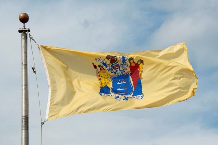 Flag of New Jersey in front of New Jersey State House, Trenton, New Jersey, USA.