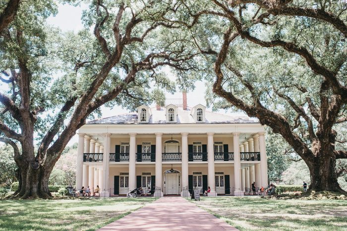 Oak Alley Plantation, Vacherie, St. James Parish, Louisiana / United States - June 28-2018: oak alley big house photo with canopy of oak trees leading to the house and tourist.