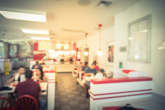 Blurred image a compact fast food restaurant in USA.