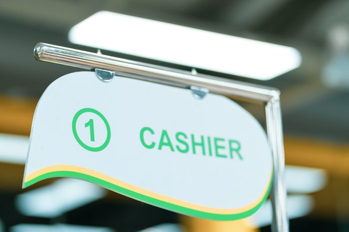 Cash-desk with cashier and terminal in supermarket
