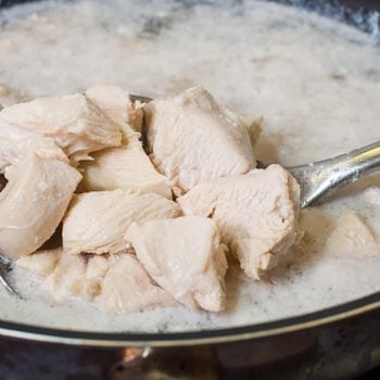 Boiled chicken breast in a pan on the sieve