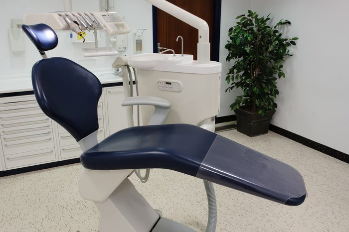 Dentist office with blue chair and tools