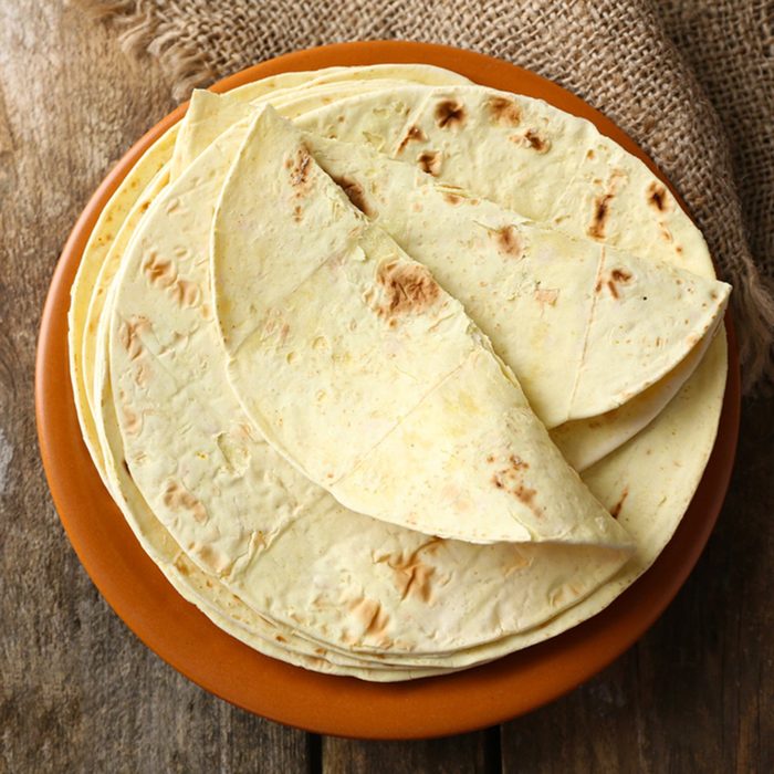 Stack of homemade whole wheat flour tortilla on plate