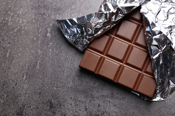 Chocolate bar in foil on gray background