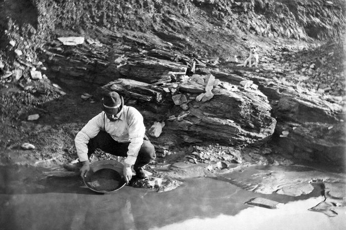 VARIOUS Dexter, Alaska: June 20, 1902. A gold miner panning for gold in Alaska.
