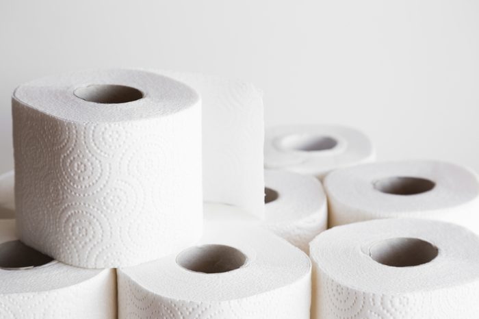 White toilet paper rolls on the gray background. Hygiene concept.