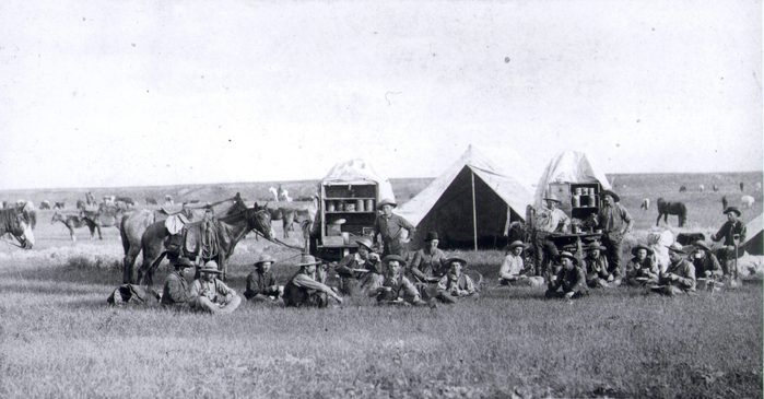Art Cowboys around chuck wagons, 1887 in the Dakota Territory