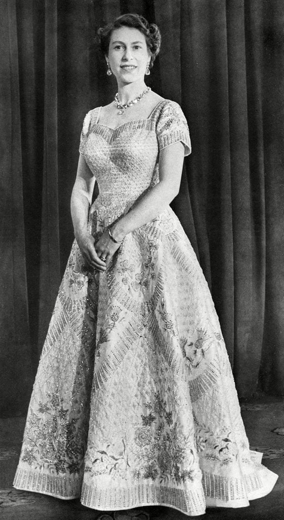 Historical Collection 84 A Photograph Taken at the Special Request of the Queen in Order to Showcase the Workmanship of the Gown the Work of Norman Hartnell It is White Satin with A Fitted Bodice and Neck-line Cut Square Over the Shoulders Before Curving Into A Heart Shape the Gown Features Golden Crystals Graduated Diamonds and Pearls As Well As Representations of the Leek of Wales Thistle of Scotland Shamrock of Ireland and Tudor Rose of England 1953