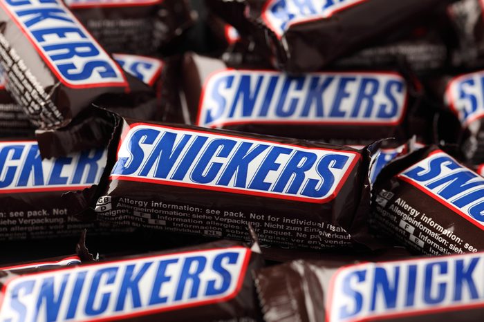 Tambov, Russian Federation - September 01, 2012: Snickers minis candy bars heap. Full Frame. Snickers bar is a chocolate bar with caramel and peanuts, manufactured by Mars, Incorporated.