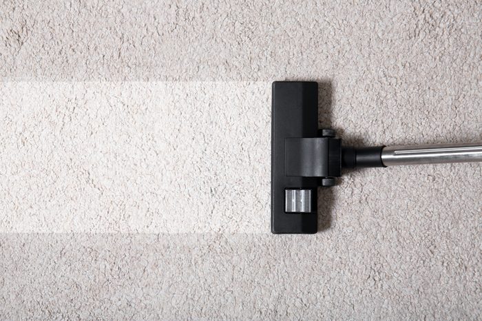 Vacuum cleaner on carpet indoors, closeup. Cleaning service