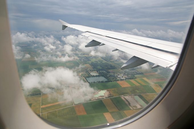 The view form inside the window of an airplane while approaching for landing at the airport of Munich, Germany