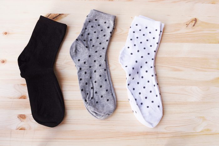 set of short socks white, grey, black on wooden background