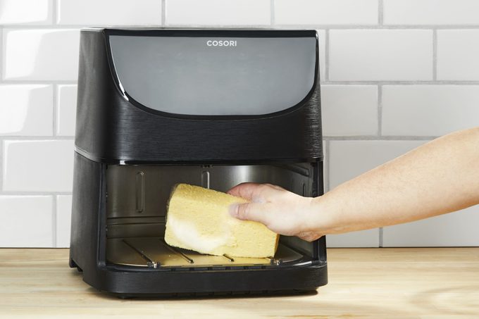 cleaning the interior of an air fryer with a sponge