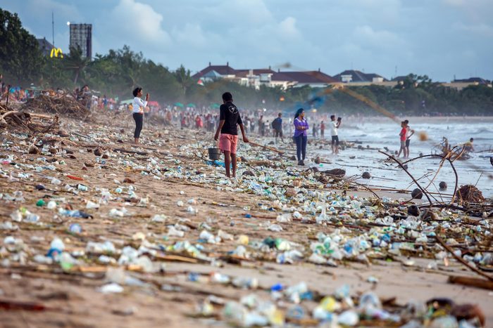 BALI, INDONESIA - FEBRUARY 12, 2017: Beach pollution at Kuta beach, Bali. Many garbage on the beach