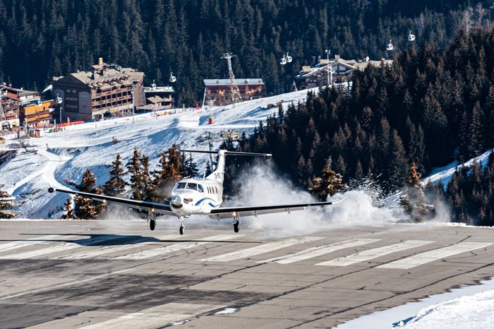 COURCHEVEL - FEBRUARY 25. A Pilatus PC12 during a dangerous landing where it has touched down before the runway! This private airplane brings skiers during French winter holidays on February 25, 2017.