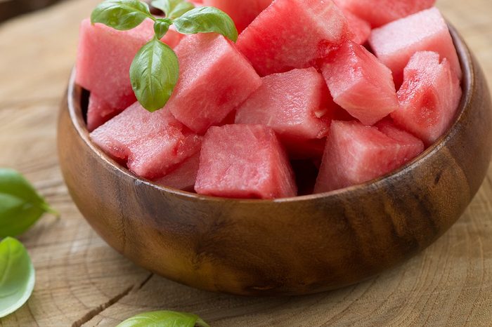 Wooden bowl with watermelon cubes, close-up, horizontal shot