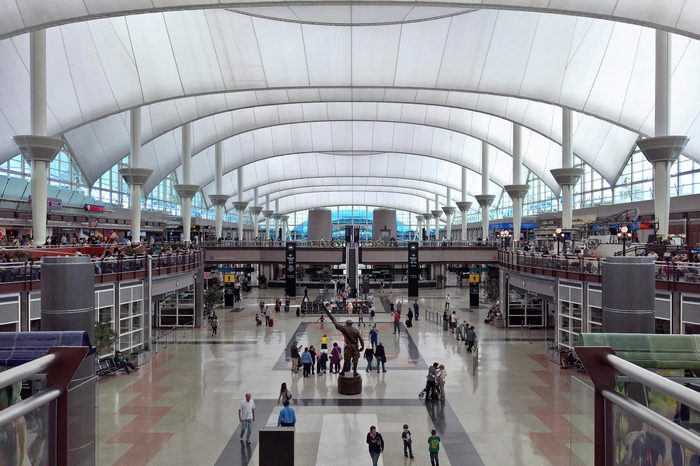 DENVER, CO - APRIL 23, 2016: Passengers traverse through the Jeppesen Terminal, (also known as the Great Hall) at Denver International Airport, DEN, a large hub airport in the central United States.