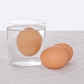 Rotten egg, salmonella risk. Old fashioned test. Bad egg floats in glass of water.; Shutterstock ID 429271258; Job (TFH, TOH, RD, BNB, CWM, CM): TOH Egg Freshness Test