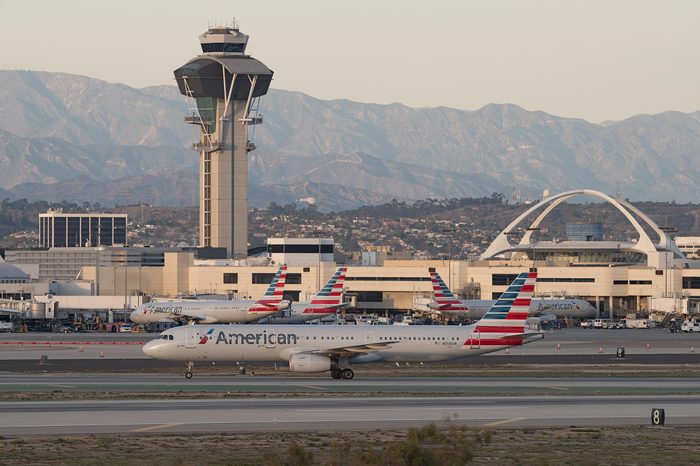 EL SEGUNDO, CA, USA - JANUARY 21, 2018: American Airlines planes at the Los Angeles International airport (LAX) with the San Gabriel mountains in the background.