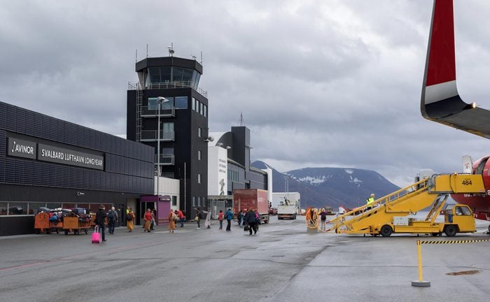 Longyearbyen, Svalbard - August 2017: Passengers disembark from Norwegian aircraft at the Svalbard airport Longyear (LYR) - northernmost airport in the world with public scheduled flights.
